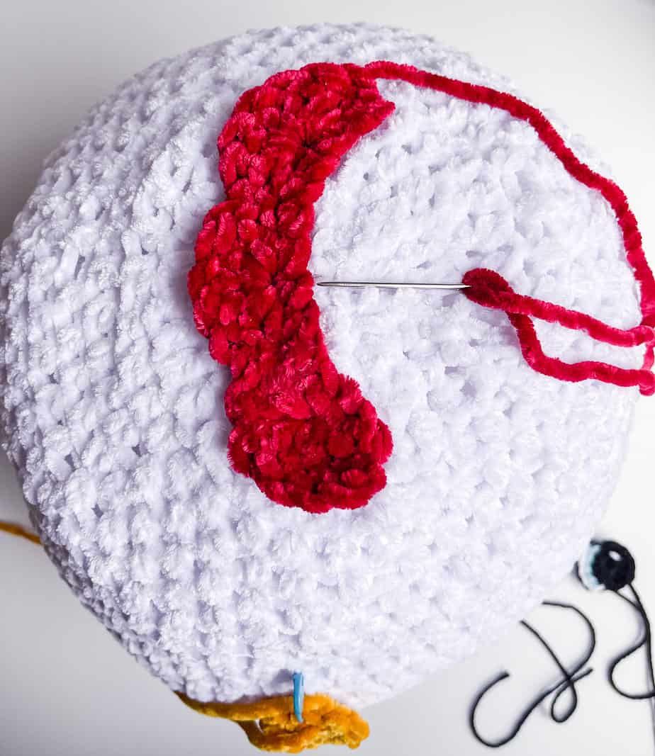 sewing comb to top of chicken process