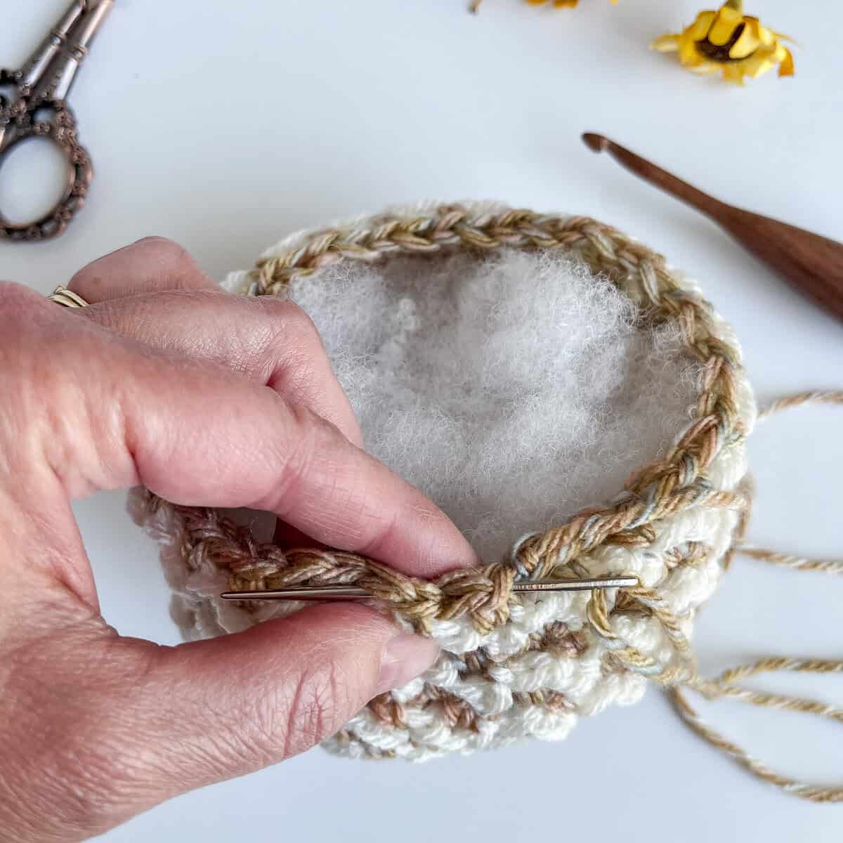 cinching top of crochet pumpkins 