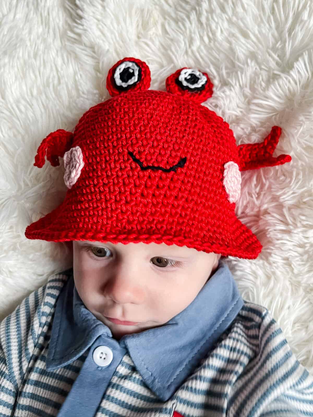 crochet crab hat in toddler size on small chld model